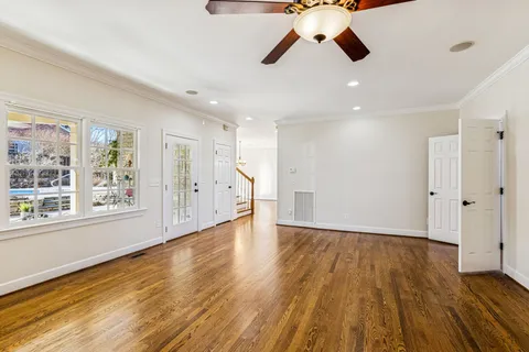 a kitchen with granite countertop a sink a stove refrigerator and cabinets