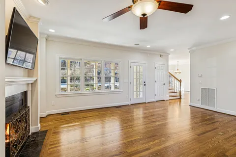 a kitchen with stainless steel appliances granite countertop a sink a stove and a wooden floors
