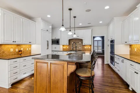 a kitchen with stainless steel appliances granite countertop a stove and a refrigerator
