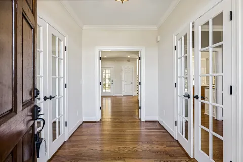 a view of hallway with wooden floor and stairs