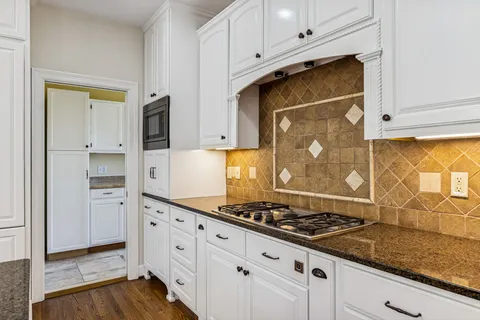 a bathroom with a double vanity sink a mirror and a bathtub