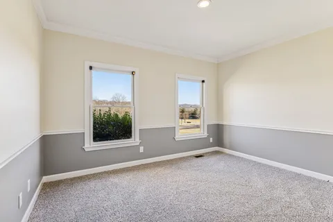 a view of an empty room with a ceiling fan
