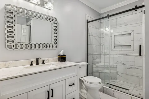 a bathroom with a sink vanity and a mirror