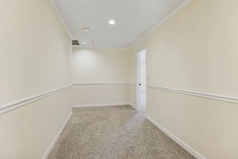 an empty room with wooden floor and window