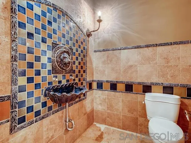 18287 Via Ambiente Rancho Santa Fe, CA 92067 - Photo 14 of 24 a bathroom with a sink and a mirror