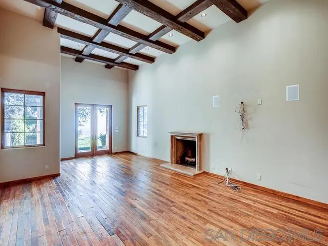18287 Via Ambiente Rancho Santa Fe, CA 92067 - Photo 15 of 24 a view of empty room with wooden floor and fireplace