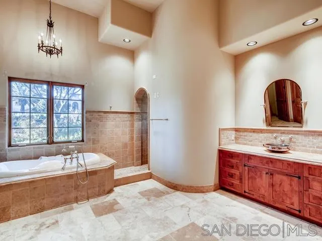 18287 Via Ambiente Rancho Santa Fe, CA 92067 - Photo 16 of 24 a spacious bathroom with a tub sink and mirror