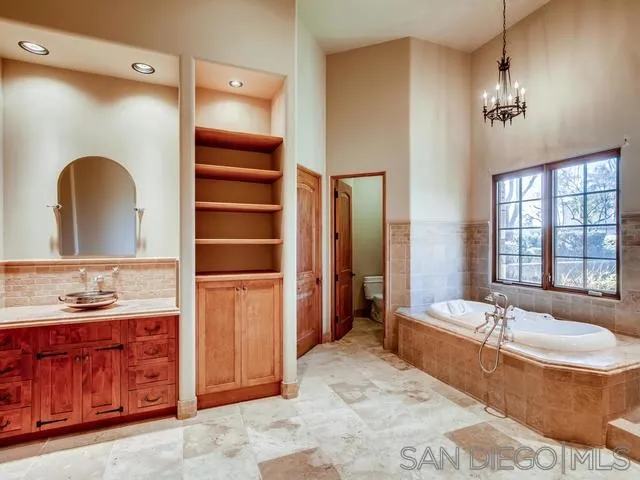 18287 Via Ambiente Rancho Santa Fe, CA 92067 - Photo 17 of 24 a spacious bathroom with a granite countertop sink and a mirror