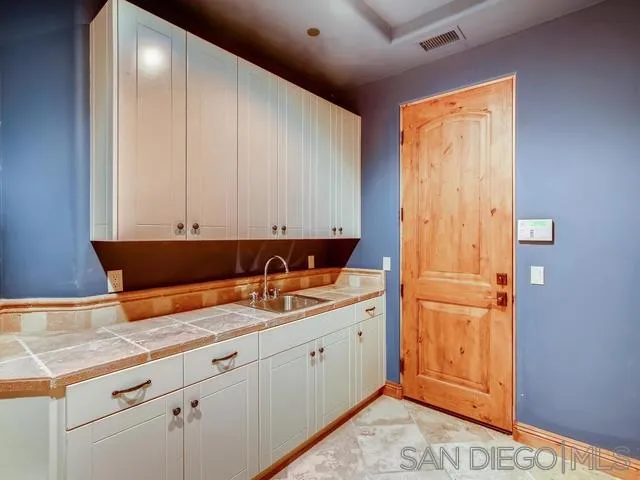 18287 Via Ambiente Rancho Santa Fe, CA 92067 - Photo 22 of 24 a kitchen with a sink and cabinets