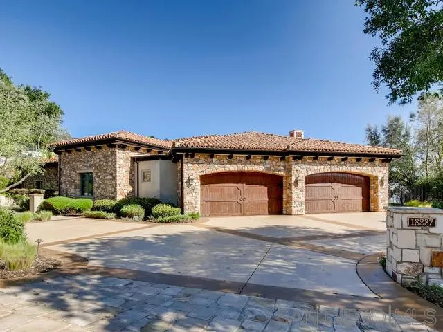 18287 Via Ambiente Rancho Santa Fe, CA 92067 - Photo 5 of 24 a front view of a house with a yard and potted plants