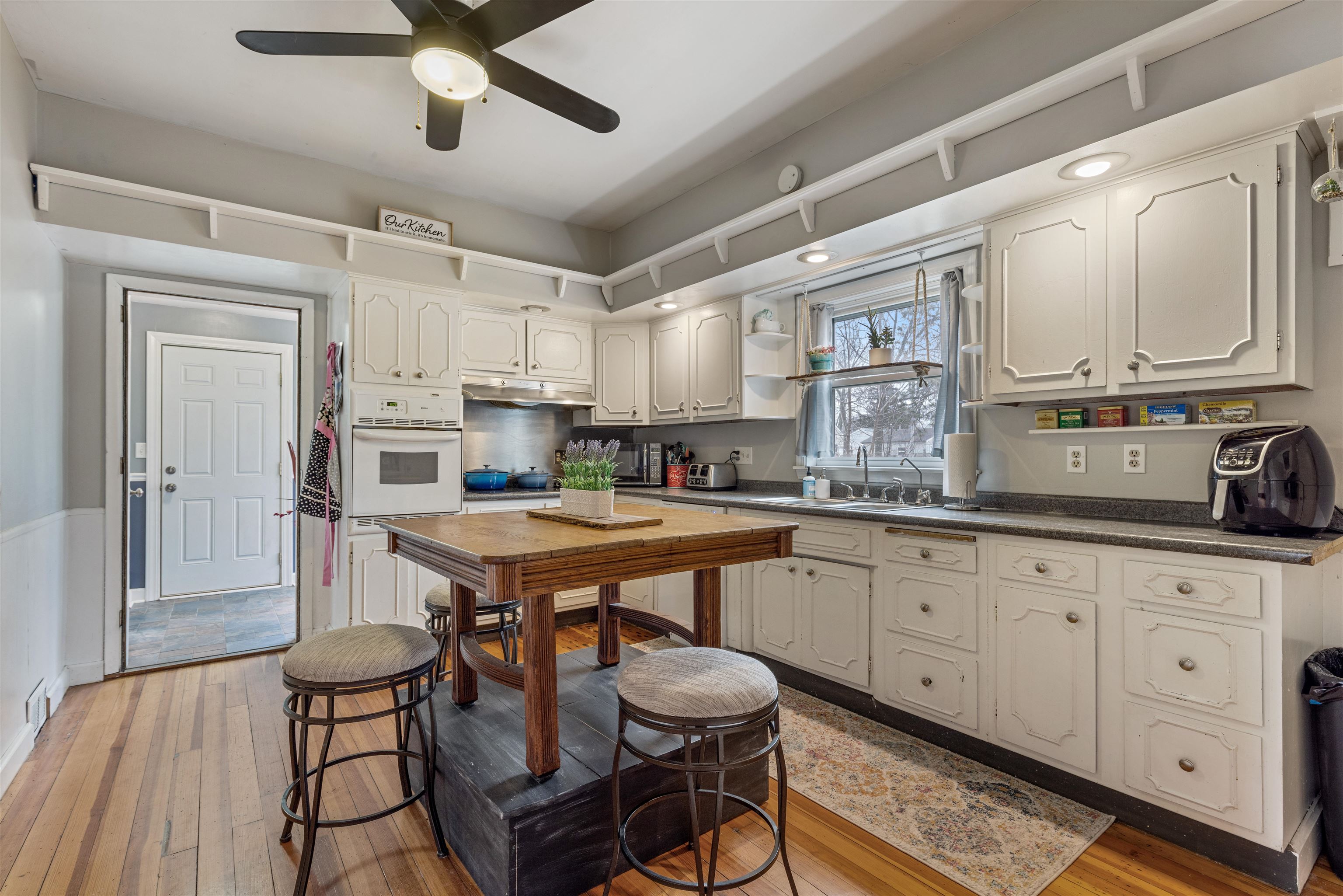 501 South 3rd Street Rochelle, IL 61068 - Photo 6 of 21 a kitchen with stainless steel appliances kitchen island granite countertop a table chairs sink and cabinets