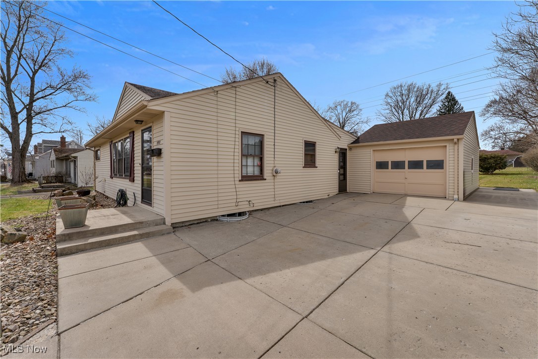 2702 Brunswick Road Youngstown, OH 44511 - Photo 2 of 18 View of property exterior featuring roof with shingles, driveway, and an outbuilding