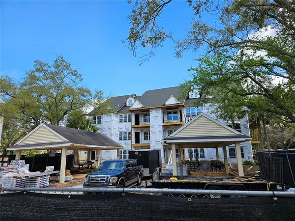 a front view of a house with swimming pool table and chairs