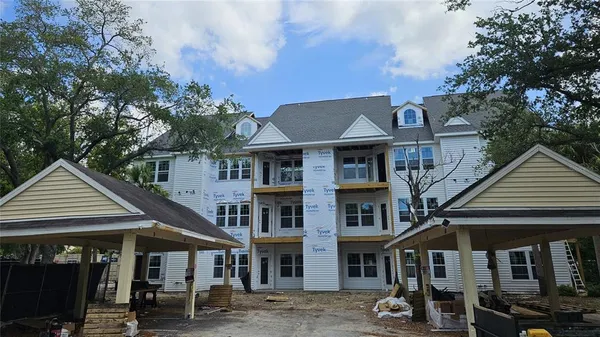 a front view of a residential apartment building with a yard