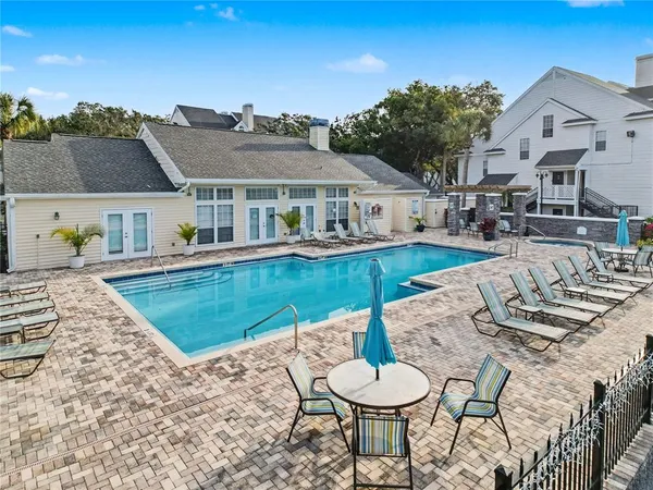 a view of a house with swimming pool and sitting area
