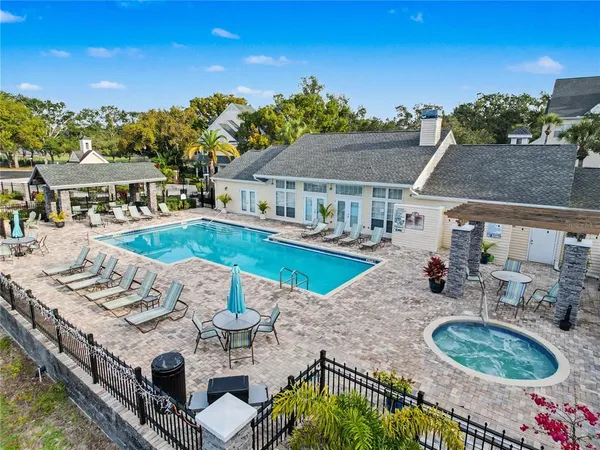 a view of a house with swimming pool and furniture