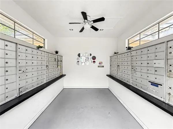 a view of room with cabinet and ceiling fan