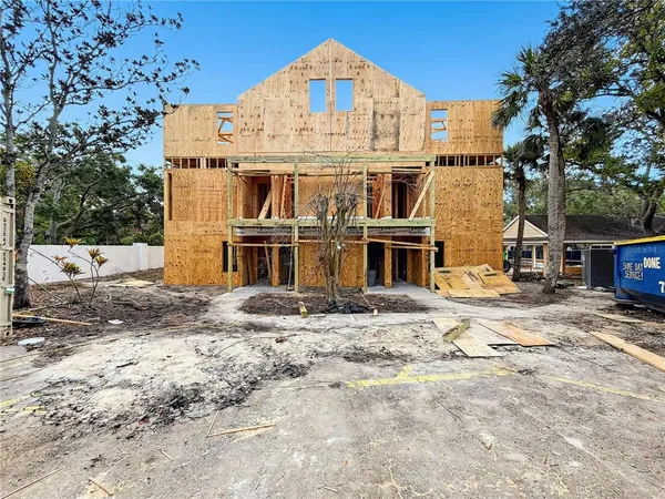 a view of a big house with a yard and garage