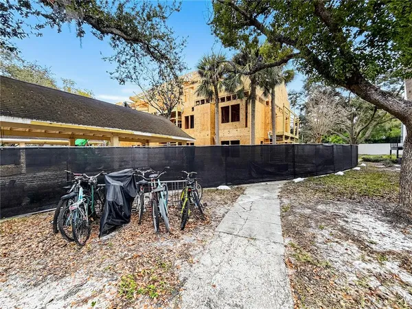 a view of a yard with table and chairs under an umbrella