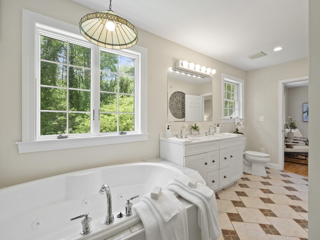 43 Ipswich Road Boxford, MA 01921 - Photo 19 of 25 a spacious bathroom with a bathtub a sink and a large mirror