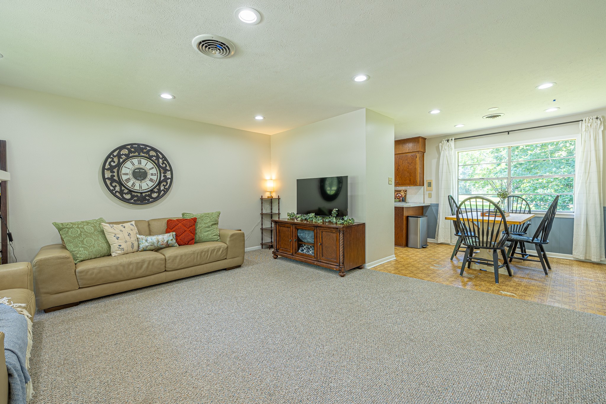 1009 Fish Hatchery Road Huntsville, TX 77320 - Photo 5 of 16 a living room with furniture a clock and a large window