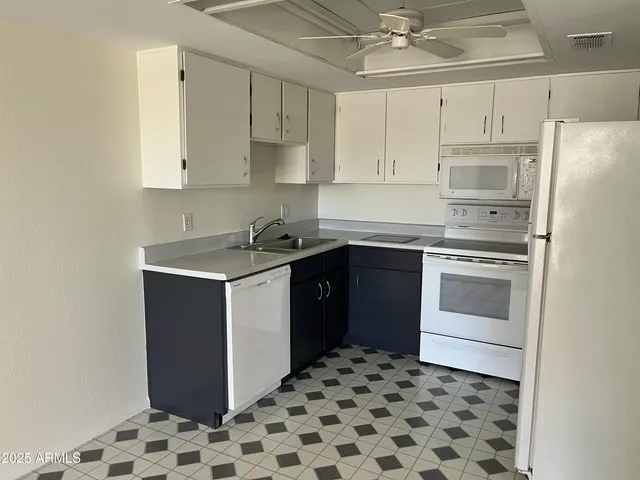 a kitchen with a sink stove and refrigerator