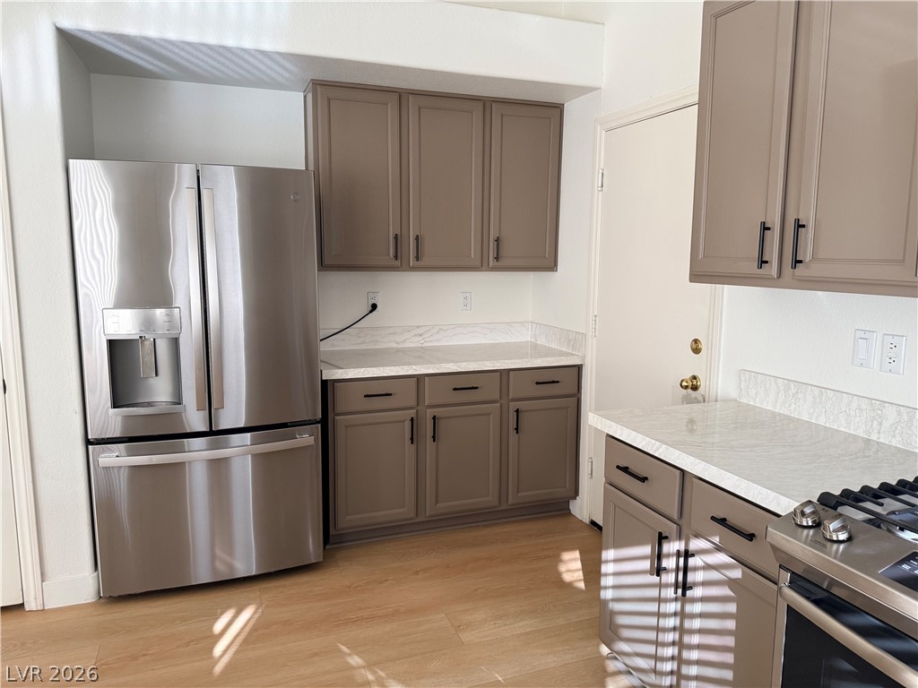 2122 Hidden Ranch Terrace Henderson, NV 89052 - Photo 10 of 20 Modern kitchen with sleek stainless steel appliances and ample counter space for culinary endeavors.