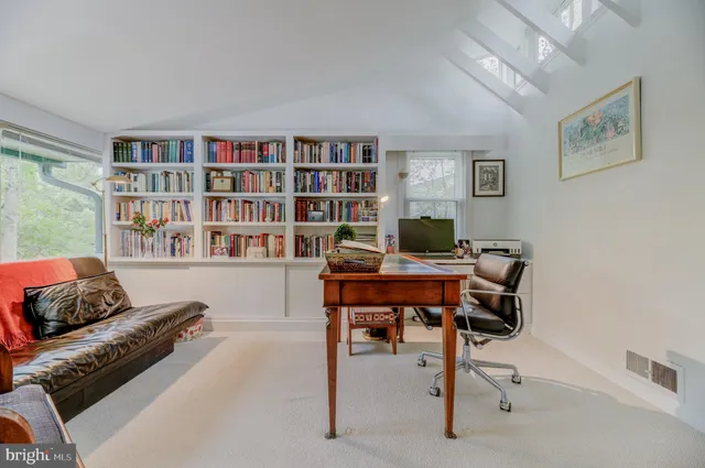 a living room with furniture and a bookshelf