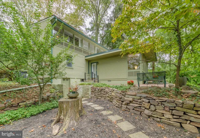 a backyard of a house with table and chairs