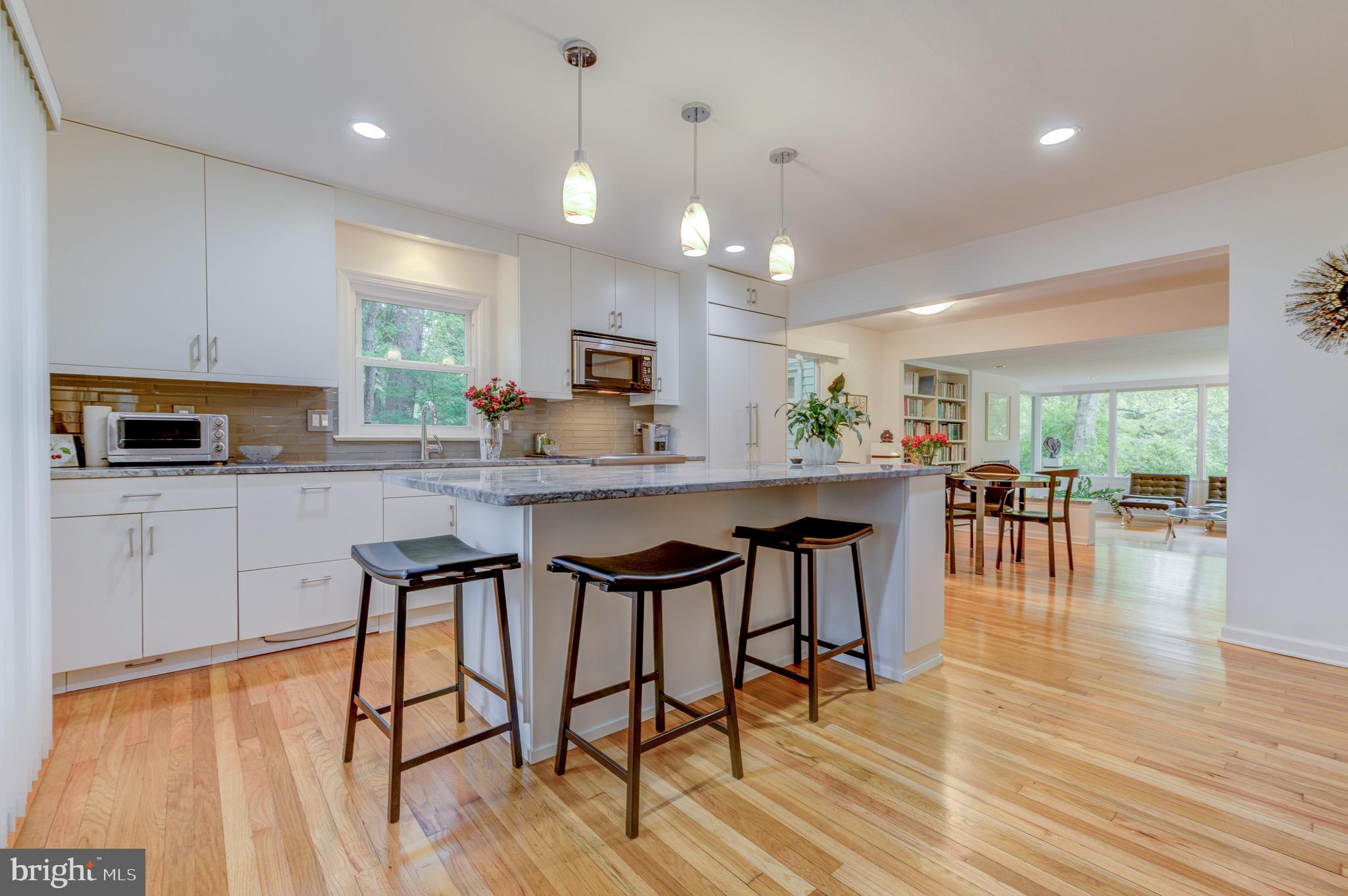 267 Hamilton Avenue Princeton, NJ 08540 - Photo 7 of 39 a kitchen with stainless steel appliances kitchen island granite countertop a stove a refrigerator a sink a dining table and chairs with wooden floor