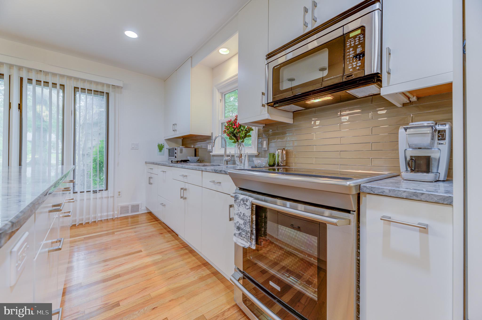 267 Hamilton Avenue Princeton, NJ 08540 - Photo 10 of 39 a kitchen with stainless steel appliances granite countertop a stove a sink and a microwave