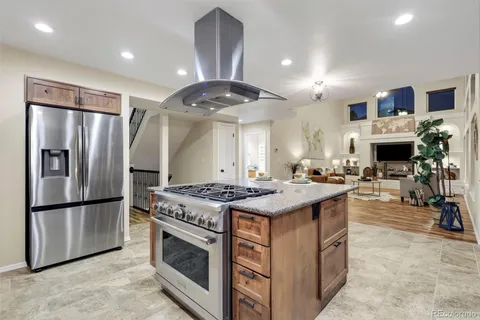 a kitchen with stainless steel appliances granite countertop a stove and a refrigerator