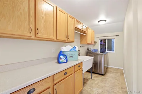 a utility room with cabinets washer and dryer