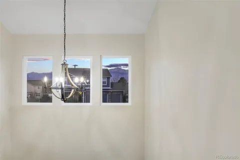 a view of a kitchen with refrigerator and double door