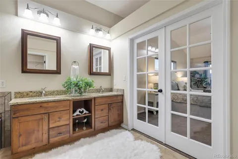 a spacious bathroom with a double vanity sink and a mirror