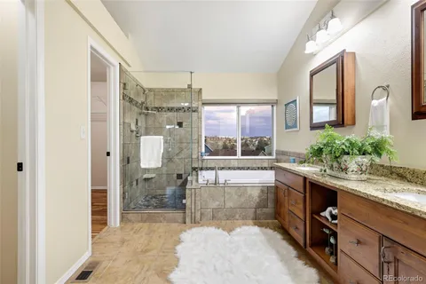 a large bathroom with a glass door shower and sink