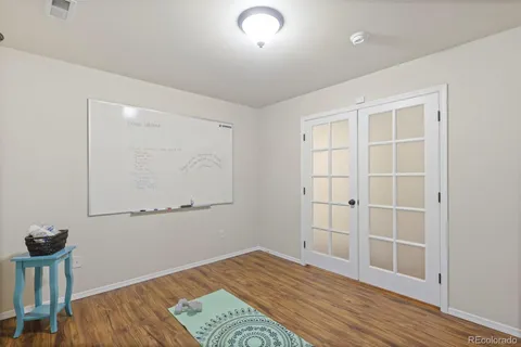 a view of empty room with wooden floor