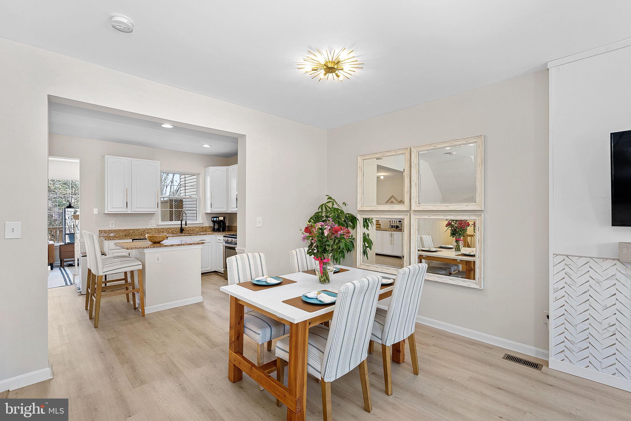 20392 Farmgate Terrace Ashburn, VA 20147 - Photo 14 of 62 a view of a dining room with furniture and wooden floor