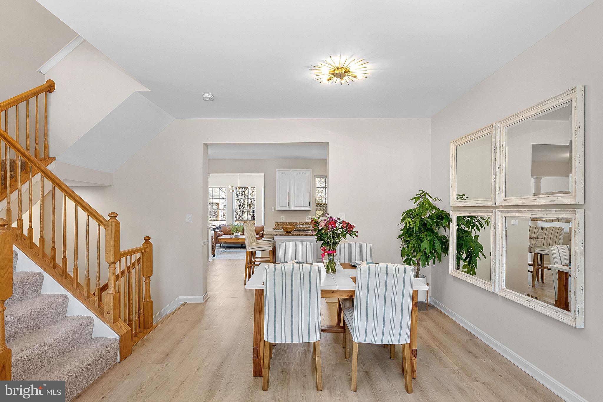 20392 Farmgate Terrace Ashburn, VA 20147 - Photo 15 of 62 a view of a dining room with furniture and a potted plant