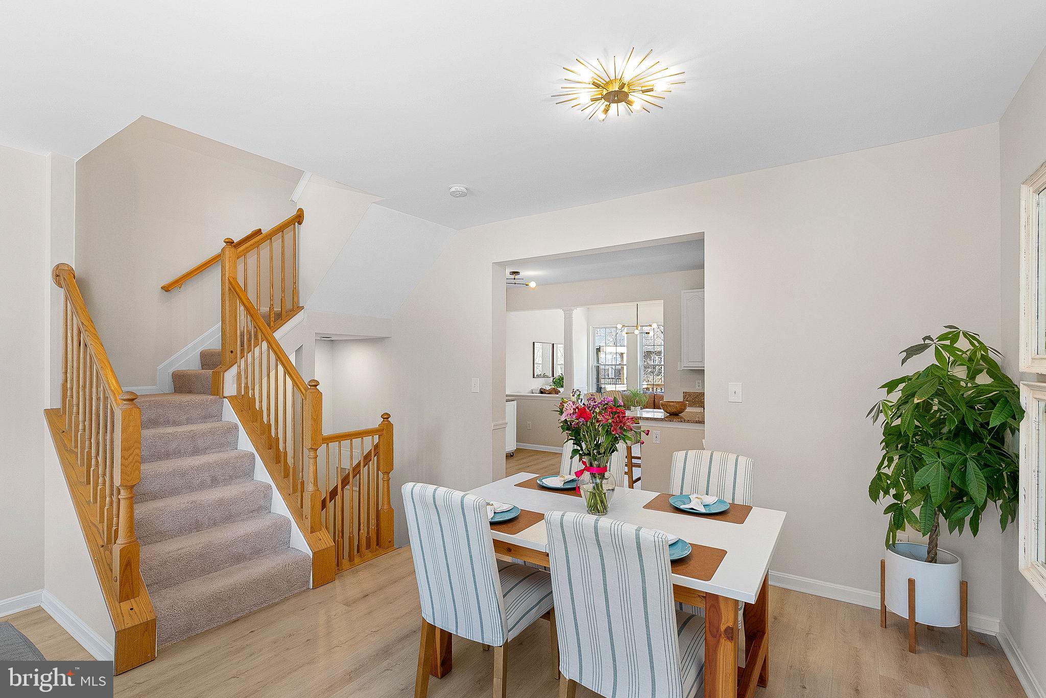 20392 Farmgate Terrace Ashburn, VA 20147 - Photo 16 of 62 a view of a dining room with furniture and wooden floor