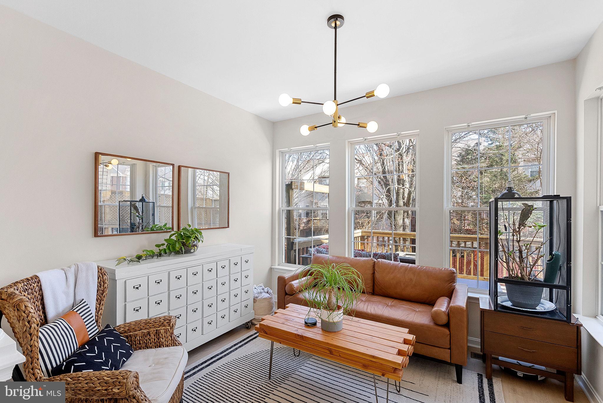 20392 Farmgate Terrace Ashburn, VA 20147 - Photo 25 of 62 a living room with furniture and a floor to ceiling window
