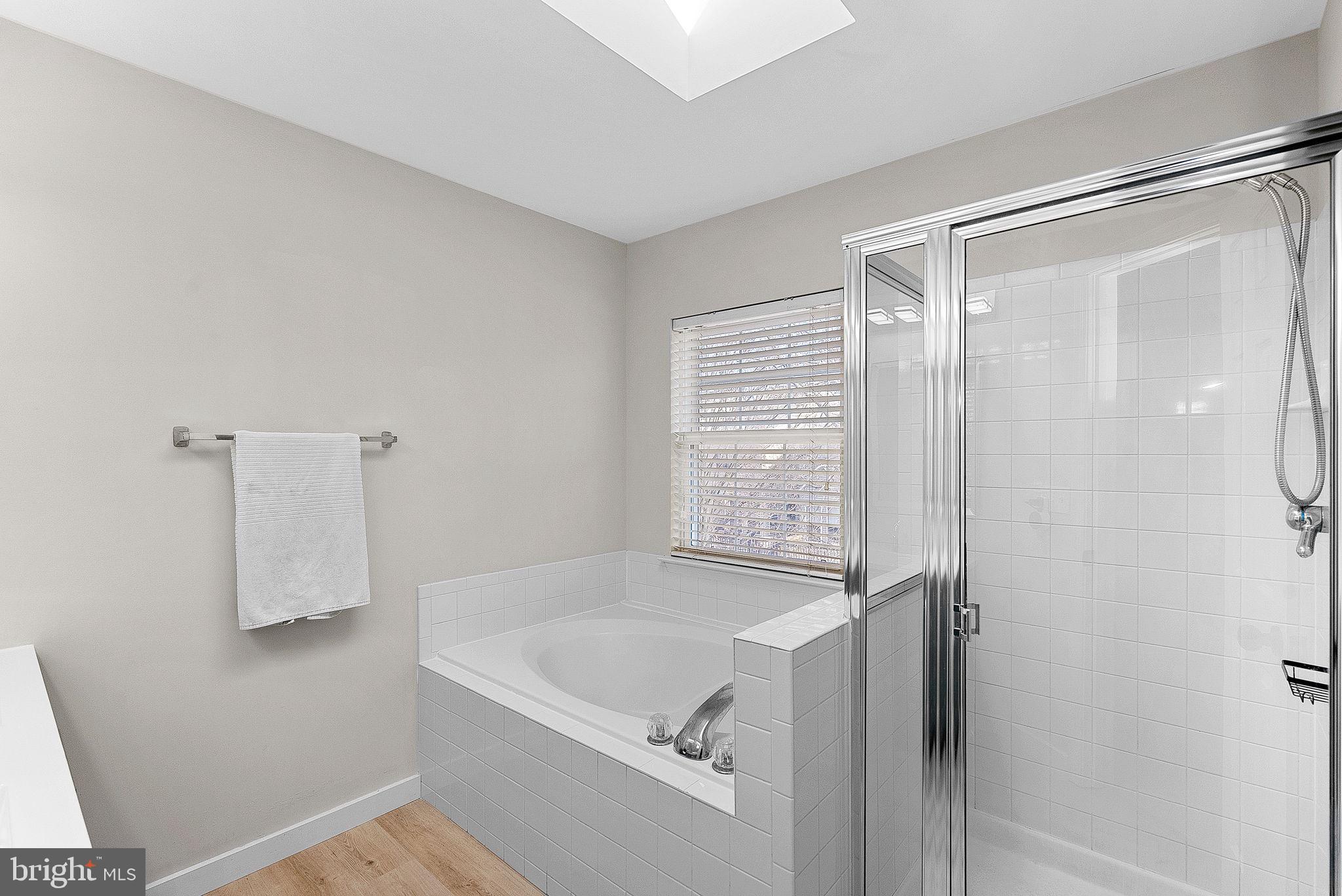 20392 Farmgate Terrace Ashburn, VA 20147 - Photo 34 of 62 a bathroom with a tub and a shower