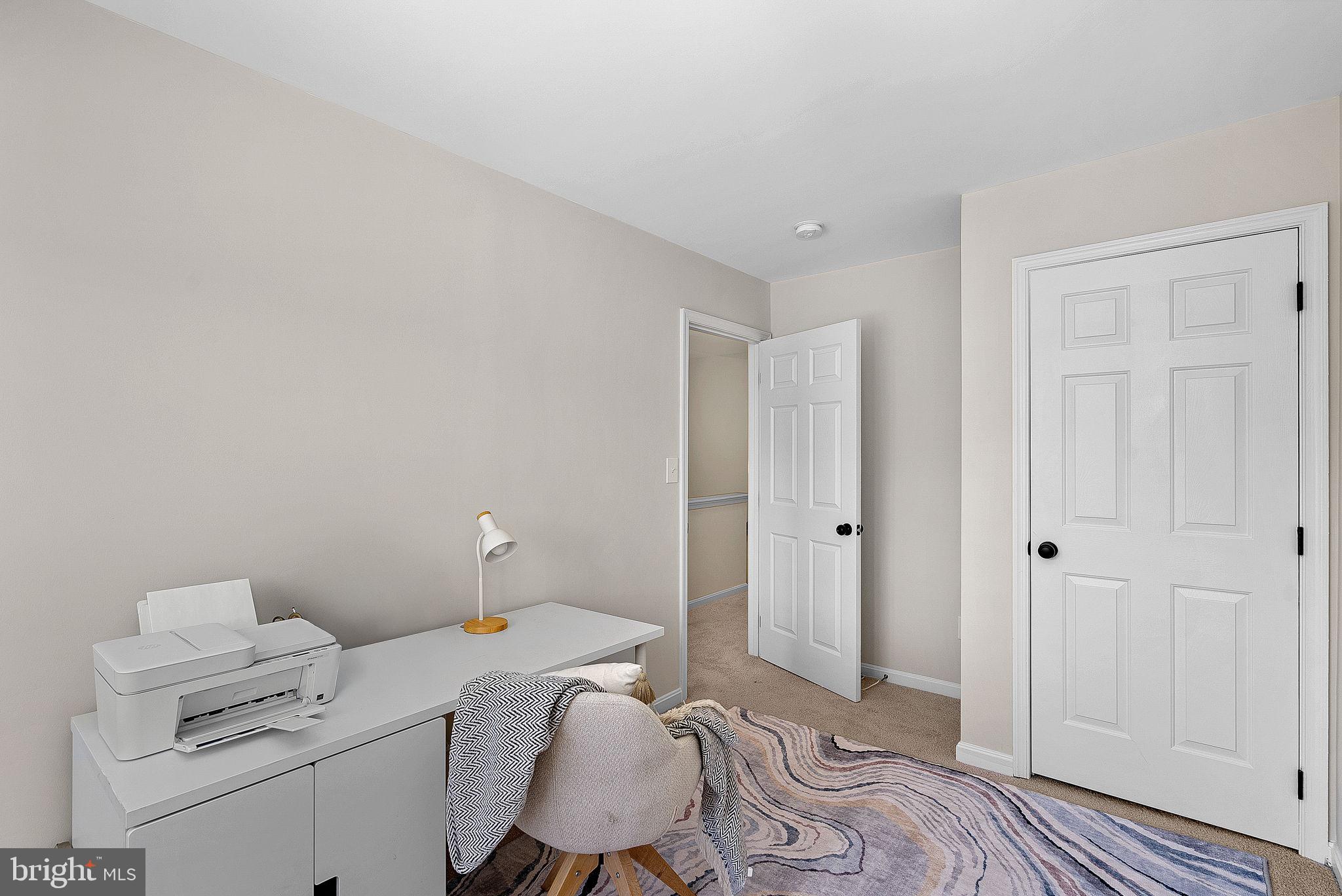 20392 Farmgate Terrace Ashburn, VA 20147 - Photo 40 of 62 a bedroom with a bed and a desk