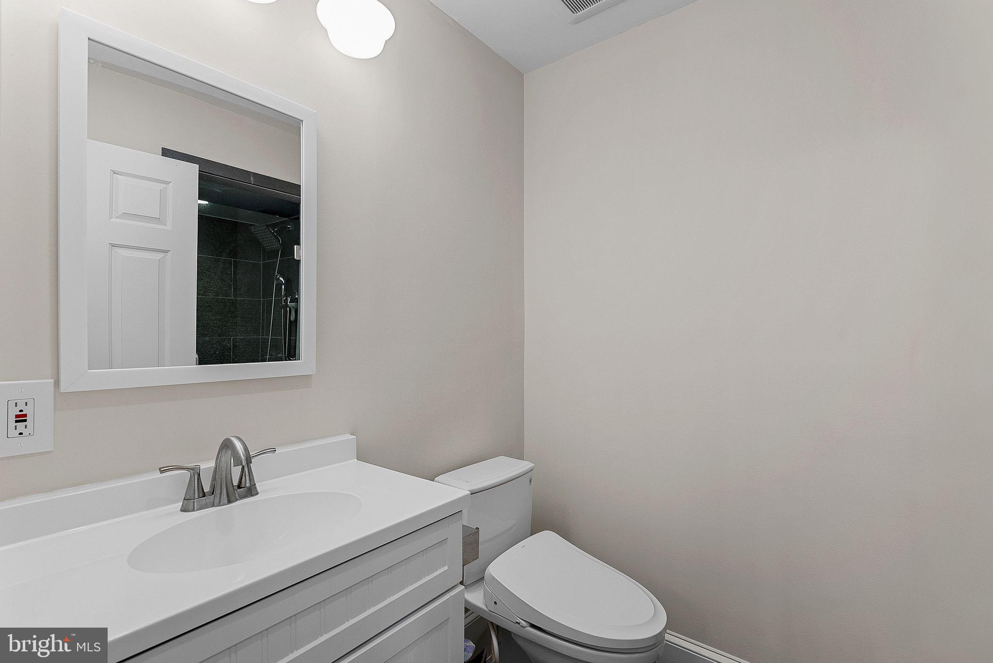 20392 Farmgate Terrace Ashburn, VA 20147 - Photo 45 of 62 a bathroom with a sink a toilet and mirror