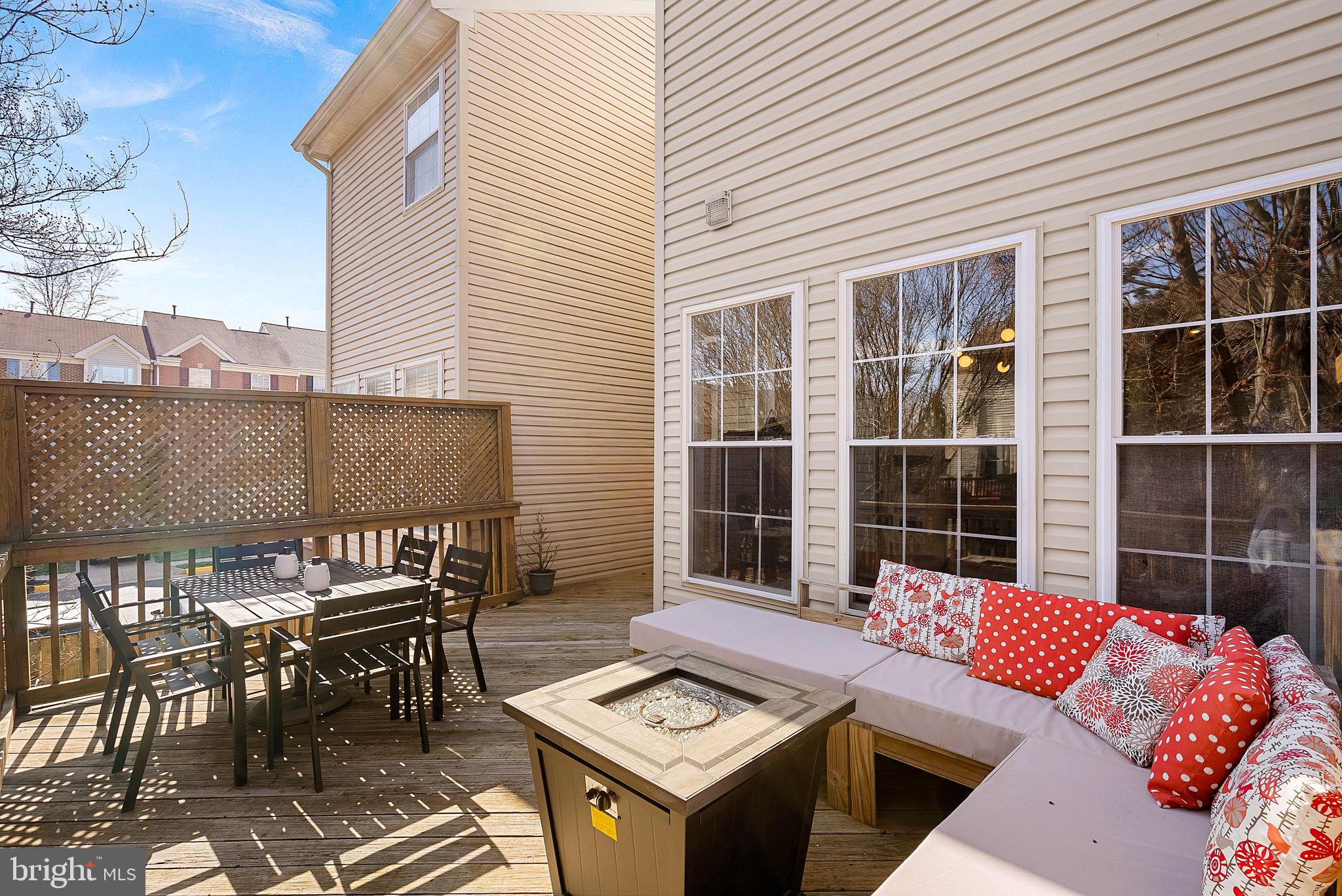 20392 Farmgate Terrace Ashburn, VA 20147 - Photo 50 of 62 a view of a patio with a table and chairs and floor to ceiling window