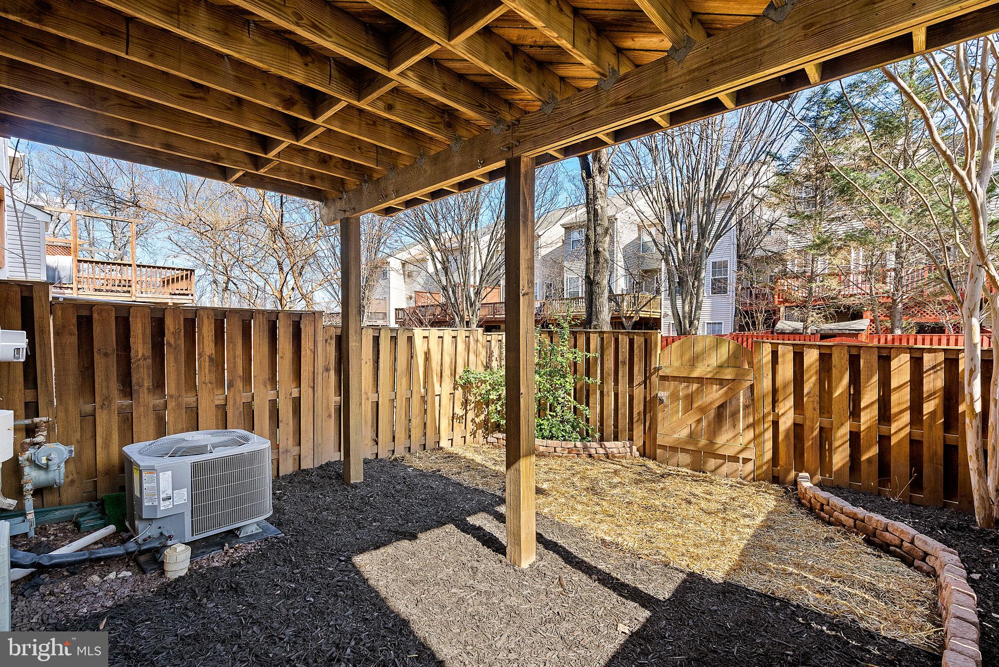 20392 Farmgate Terrace Ashburn, VA 20147 - Photo 53 of 62 a view of a backyard with wooden fence