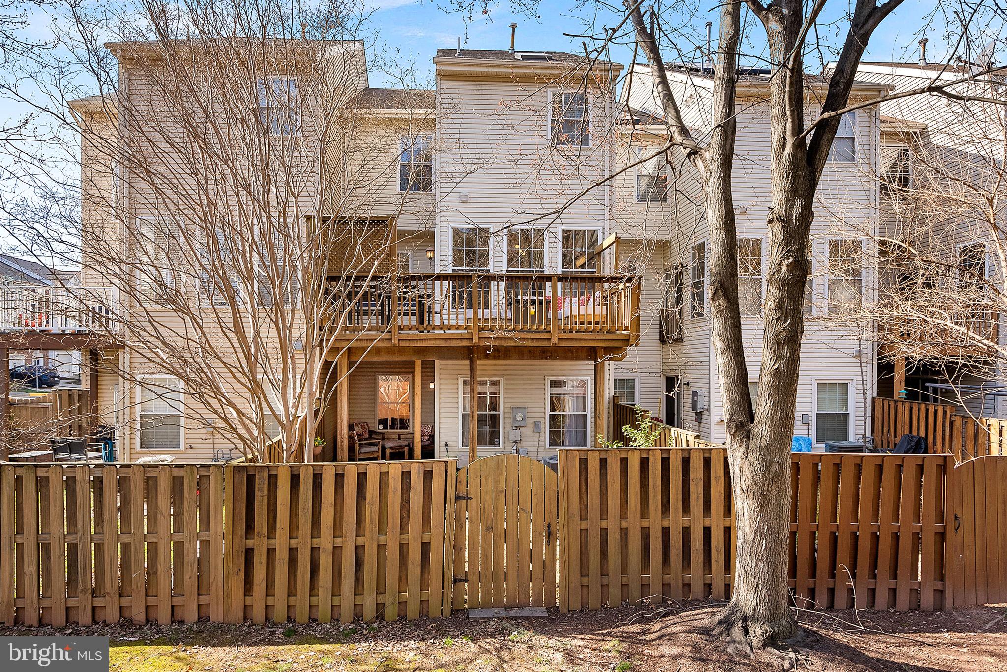 20392 Farmgate Terrace Ashburn, VA 20147 - Photo 57 of 62 a front view of a house with a iron gate