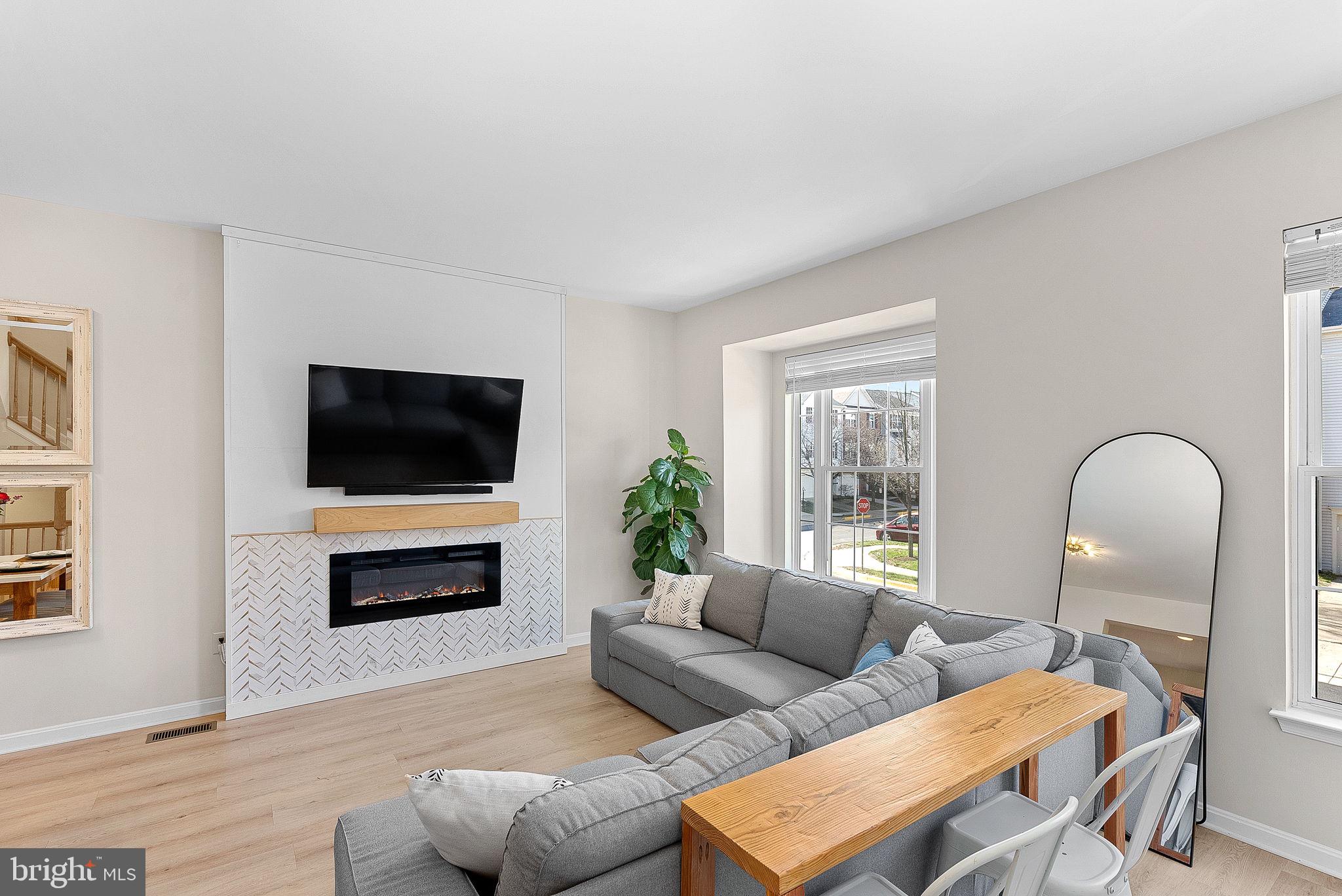 20392 Farmgate Terrace Ashburn, VA 20147 - Photo 7 of 62 a living room with furniture and a flat screen tv