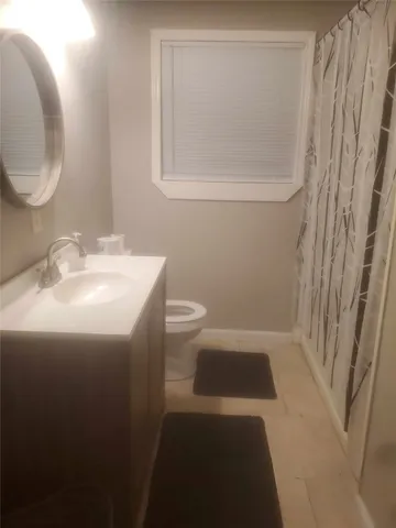 a bathroom with a sink a toilet and a mirror