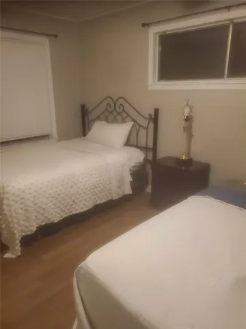 a bedroom with a bed and a night stand